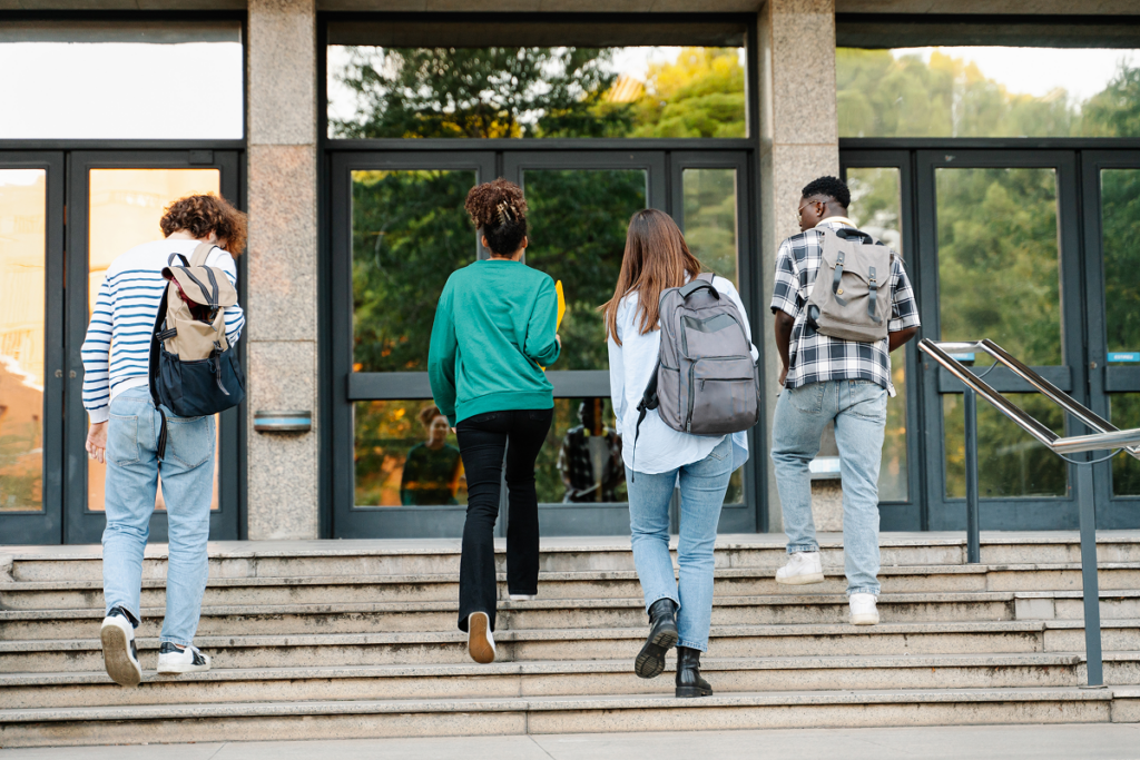 Alunos entrando na faculdade. Valor da faculdade de Administração em diferentes regiões e modalidades.