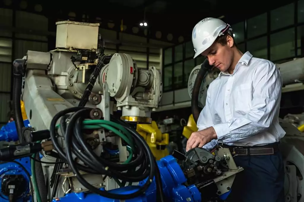 homem analisando máquina de grande porte